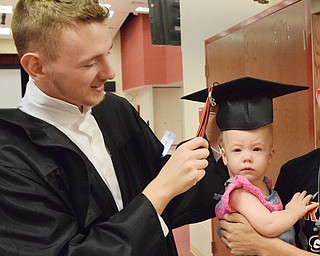 William D. Lewis The Vindicator  Girard grad Randy Griffith tries his mortar board on his niece Bailey Stewart, 1, before 5-27-18 commence at GHS.