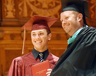 William D. Lewis The Vindicator Mooney principal MArk Vollmer opresents diploma to grad Vincent Anthony Pecchia during5-27-18 commencement.