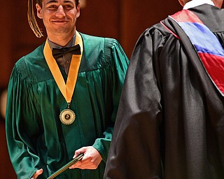 YOUNGSTOWN, OHIO - MAY 27, 2018: Colt Jamieson smiles after receiving his diploma from Principal Matthew Sammartino during the Ursuline High School graduation ceremony, Sunday afternoon at Stambaugh Auditorium. DAVID DERMER | THE VINDICATOR