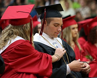 Valedictorians Adrianna Leonard (left) fixes the cord of Anthony Iarussi during the Struthers High School Commencement on Sunday afternoon.   Dustin Livesay  |  The Vindicator  5/27/18  Struthers.