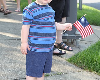 Jaxy Millerleile (1.5) of Poland holds a flag while watching the police cars go by during the Memorial Day Parade in Poland on Monday morning. Dustin Livesay  |  The Vindicator  5/28/18 Poland