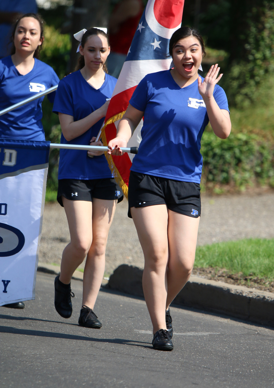 Poland senior flagline member, Chelsea Kilgore waves to spectators as she marches with the Poland Seminary Marching Band during the Memorial Day Parade in Poland on Monday morning. Dustin Livesay  |  The Vindicator  5/28/18 Poland