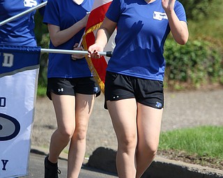 Poland senior flagline member, Chelsea Kilgore waves to spectators as she marches with the Poland Seminary Marching Band during the Memorial Day Parade in Poland on Monday morning. Dustin Livesay  |  The Vindicator  5/28/18 Poland