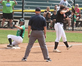 ROBERT K YOSAY  | THE VINDICATOR..West Branch Warriors - defeated Jonathan Alder Pioneers  - 5-4 where the lead changed hands several times ...WB 7 Grace Heath - checks with the umpire as she slides past the throw to Aldens 3rd Base  #33  Jillian Jake...during third inning action..-30-