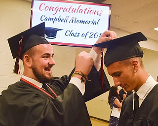 William D. Lewis The Vindicator Campbell grad George Koulianos, left, gives fellow grad Ross Clark a hand with his motar board before 5-31-18 commencement at Campbell HS.