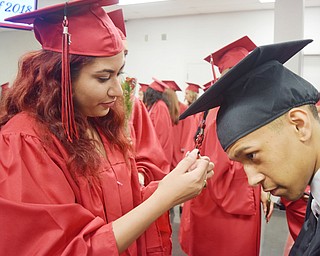 William D. Lewis The Vindicator  Campbell grad Sara Kamal braids  fellow grad Devontay Johnson's tassle before 5-31-18 commencement at Campbell HS.