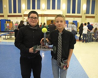 Neighbors | Zack Shively.The STEM showcase demonstrated the students' abilities and the different activities and projects the students do in the STEM program. Pictured are Devin Ramhoff and Pete Shrake with a remote controlled robot that could pick up a tennis ball.