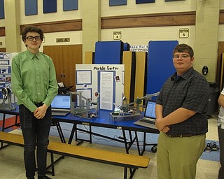 Neighbors | Zack Shively.STEM instructor Danielle Chine wanted the showcase to present the students' hard work and the cirriculum of the program. She said the program gives the students a 21st century learning environment with real life applications. Pictured are Squire Strickland and Zackary Shumaker with their marble sorter machines.
