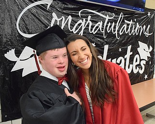 William D. Lewis The Vindicator  Canfield grad Thomas Beck shares a moment with fellow  grad Christina Rivera before 6-1-18 commencement at CHS. Beck is graduating from the special needs program at Canfield. Rivera had taken a class called Helping Hands where she met Beck.