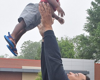 William D. Lewis The Vindicator  Jay King lifts his cousin Ricky Williams, 1, in the air during the Unity Parade 6-2-18 on Market St in Youngstown.