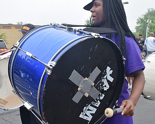 William D. Lewis The Vindicator Jahniya Carnathan plays bass drum with Time Keepers Drumline during 6-2-18 Unity Parade in Youngstown.