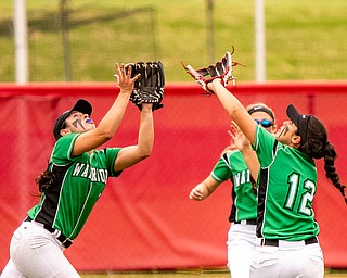 DIANNA OATRIDGE | THE VINDICATORÊ West Branch's Delaney Rito (left) and Destany Blake (right) converge on a fly ball in shallow center field as Grace Heath (center) looks on during their Division II State Championship Game in Akron on Saturday. West Branch lost to Keystone 3-2 in a 12 inning marathon..