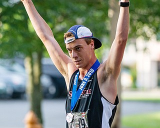 Scott R. Galvin | The Vindicator.Mack Mettille of Canfield celebrates after he crossed the finish line first in the 5K run at the first inaugural Youngstown Marathon on Sunday, June 3, 2018.