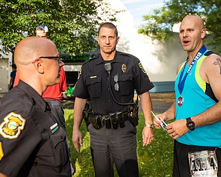 Scott R. Galvin | The Vindicator.Jake Lape, right, talks with Boardman Police Sgts. Glenn Patton and Brian Habeger following his 5th place finish in the 5K run at the first inaugural Youngstown Marathon on Sunday, June 3, 2018.  Lape is also a police officer with Boardman Township.