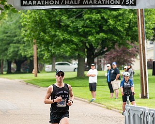 Scott R. Galvin | The Vindicator.Jon Hutnyan of Baltimore, Maryland, crosses the finish line first in the half marathon run during the first inaugural Youngstown Marathon on Sunday, June 3, 2018.