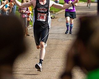 Scott R. Galvin | The Vindicator.Erik Reed of East Liverpool celebrates as he runs toward the finish line finishing first in the first inaugural Youngstown Marathon on Sunday, June 3, 2018.