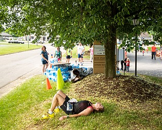 Scott R. Galvin | The Vindicator.Linda Reeder of Westerville, Ohio, rests under the shade of a tree following her finish in the half marathon at the first inaugural Youngstown Marathon on Sunday, June 3, 2018.