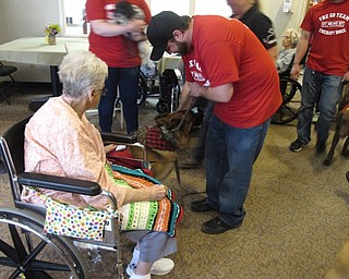 Neighbors | Zack Shively.Traci McCoy, the Recreational Director at Beeghly Oaks, said the residents were excited to meet with the therapy dogs. Pictured, Roberta Azara pet the 19 dogs that Sit Means Sit Mahoning Valley brought to the facility.