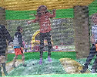 Neighbors | Abby Slanker.A Hilltop Elementary School third-grader bounced high into the air in the bouncy house during the school’s annual Student Appreciation Day.