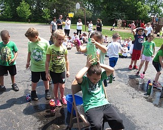 Neighbors | Zack Shively.Kendal Daltorio, Stadium Drive's physical education teacher, organized the many activities for the students to participate in during the school's field day. Pictured, the children played a water relay game where they squeezed water from a sponge and into a bottle. Daltorio added the event to this year's activities and had not done it before.