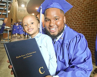 ROBERT K YOSAY  | THE VINDICATOR..Happy Family - as Freeman Davis Sr.shares his diploma with Freeman Davis Jr...(4) as he graduated  in Practical Nursing..Ford Family Recital Hall located in the DeYor Performing Arts Center. More than 60 full time students graduated from the three adult education programs offered at Choffin: 15 Dental Assisting students, 33 Practical Nursing students, and 18 Surgical Technology students..-30-