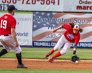 DIANNA OATRIDGE | THE VINDICATORÊ ÊHowland's Dylan Keller scoops up a grounder as his Trumbull County teammate, Lakeview's Daniel Brammer, watches the play during the All-Star Classic at Eastwood Field in Niles on Friday.