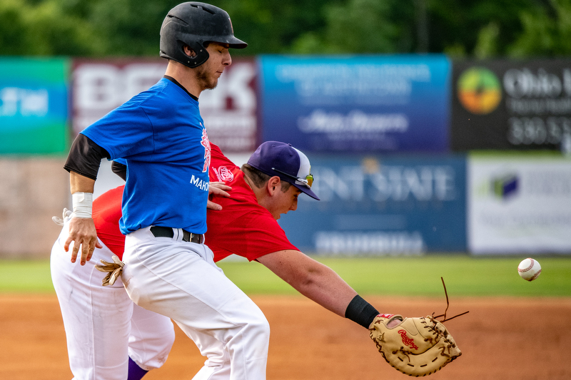 DIANNA OATRIDGE | THE VINDICATORÊ ÊBoardman's Evan Knaus is safe at first base for the Mahoning team after an errant throw to the Trumbull team's first baseman, AJ Meyer, from Champion during the All-Star Classic at Eastwood field in Niles on Friday.
