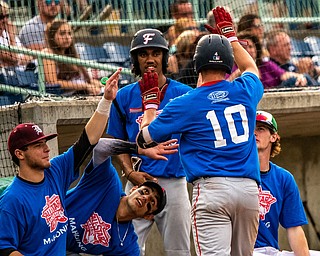 DIANNA OATRIDGE | THE VINDICATORÊ Austintown Fitch's Kole Klasic (10) scores a run and gets high fives from his Mahoning teammates, from left to right, Boardman's Alex Cardona, Canfield's Alex Hernandez, Austintown Fitch's Jeremiah Papa, and West Branch's TJ Shields during the All Star Classic at Eastwood Field in Niles on Friday.