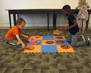 Neighbors | Zack Shively.The Austintown library's "Hooray for Doughnut Day!" featured activities and games for the children at the event. The games included Twister, tic-tac-toe, a disc toss game and a memory game. Pictured, Wyatt Cline and Jeremiah Burt played a game of tic-tac-toe.