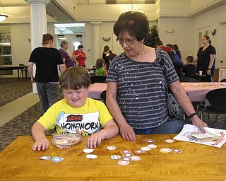 Neighbors | Zack Shively.The Austintown library had a doughnut-based memory game, where the attendees flipped over doughnuts and tried to remember where doughnuts of the same color were. Pictured, Justus Long and Ruth Huntington played the game together.