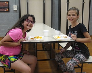 Neighbors | Zack Shively.West Boulevard invited their fourth-grade students back to the school on the night of May 31 for the school's annual fun night. The school organizes activities for the fourth-grade students to participate in during the night. Pictured, Phaline McMillen and Victoria Donatelli ate pizza that the school bought for the students.