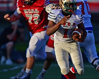 CANFIELD, OHIO - JUNE 14, 2018: Mahoning County's Joe Floyd runs the ball away from Trumbull County's Bailey Litz during the second half of the Jack Arvin All Star Football game, Thursday night at Canfield High School. DAVID DERMER | THE VINDICATOR