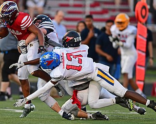 CANFIELD, OHIO - JUNE 14, 2018: Trumbull County's Dra Rushton is tackled by Mahoning County's JaQwon Dow, Brandon Walters and Mike Ferree during the second half of the Jack Arvin All Star Football game, Thursday night at Canfield High School. DAVID DERMER | THE VINDICATOR
