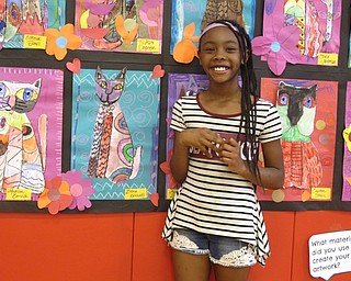 Neighbors | Zack Shively.The Austintown Elementary School hosted a second-grade art night. The night showcased many works from all second-graders in the school. Pictured, Ziara Kennedy stood next to her artwork.