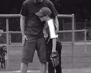 Heather Craver sent in this photo of her husband, David, and their son, Nate, conferring at a recent baseball game.
