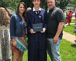 Sharmayne Gay says that husband Michael Gay is “an amazing father and best friend to our four kids.” Here, the couple stand with their oldest son, Bryson, at his graduation from Austintown Fitch High School this year.
