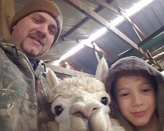 The father of four boys, Landon, Blake, Mason and Luke, John Hahn Jr. and his family live on a farm in Diamond where they raise alpacas. Here, he and Blake show one of their furry specimens. Two of the boys will show alpacas at the Canfield Fair. Liz Hahn sent in this photo of her son and grandson.

