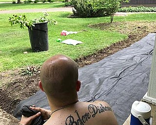 Krista Horvath, with the help of daughters Lily and Sidney, snapped this shot of husband, father and veteran Anthony J. Horvath taking a break from a landscaping project at their home in Poland. 
