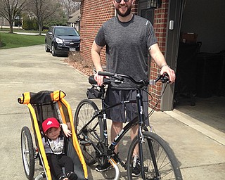 Dr. Joseph Rousher enjoys pedaling his bike around Canfield with son, Finn, at his  side. Rousher’s wife, Amy, submitted the photo.
