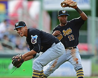 NILES, OHIO - JUNE 15, 2018: West Virginia Black Bears starting pitcher Alex Manasa, left, looks to first after avoiding a collision with Raul Siri while Mahoning Valley Scrappers' Jose Fermin was safe at first in the first inning, Friday night at Eastwood Field. DAVID DERMER | THE VINDICATOR