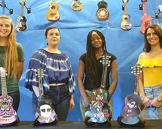 Hubbard Music Store in the Eastwood Mall is unveiling ukuleles that were hand painted by Lakeview, Hubbard and Liberty students Alissa Rodgers, from left, Hannah Best, Zion Jones and Taylor Begeot.