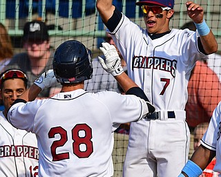 NILES, OHIO - JUNE 17, 2018: Mahoning Valley Scrappers' Simeon Lucas is welcomed back to the dugout by Tyler Freeman, right, after hitting a solo home run in the sixth inning of a baseball game against the West Virginia Black Bears, Sunday afternoon. The Scrappers won 10-9. DAVID DERMER | THE VINDICATOR