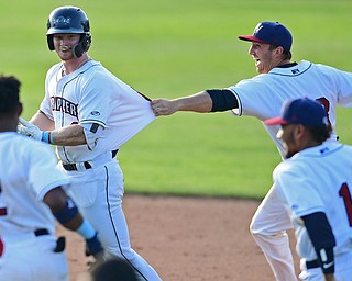NILES, OHIO - JUNE 17, 2018: Mahoning Valley Scrappers' Mitch Reeves, left, is mobbed by his teammates Simeon Lucas, Hosea Nelson and Elvis Perez after hitting a game winning single in the ninth inning of a baseball game against the West Virginia Black Bears, Sunday afternoon. The Scrappers won 10-9. DAVID DERMER | THE VINDICATOR
