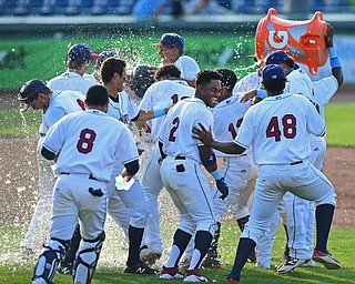 NILES, OHIO - JUNE 17, 2018: Mahoning Valley Scrappers' Mitch Reeves gets a Gatorade bath while being mobbed his teammates after hitting a game winning single in the ninth inning of a baseball game against the West Virginia Black Bears, Sunday afternoon. The Scrappers won 10-9. DAVID DERMER | THE VINDICATOR