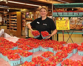 White House Fruit Farms owner, Debbie Pifer sets out fresh strawberries during the Strawberry Festival at White House Fruit Farms in Canfield on Sunday afternoon.  Dustin Livesay  |  The Vindicator  6/17/18  Canfield.