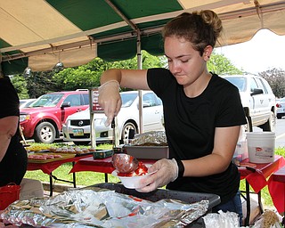Cassandra Wasilewski of Austintown prepares a strawberry sundae for a customer during the Strawberry Festival at White House Fruit Farms in Canfield on Sunday afternoon.  Dustin Livesay  |  The Vindicator  6/17/18  Canfield.