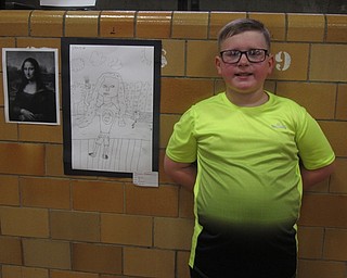 Neighbors | Zack Shively.Boardman Center Intermediate School had a book sale and an art show on May 3. The art show showcased the works of all students in the school. Pictured, Daniel Becker stood by his piece, "Modern Day Mona Lisa."