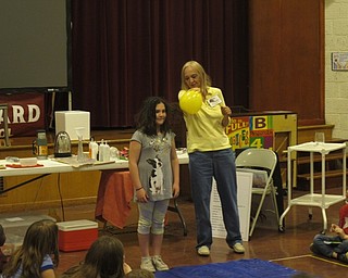 Neighbors | Zack Shively.Boardman elementary schools had their annual Right to Read Week, which included assemblies, guest readers and rewards for reading. West Boulevard Elementary invited children's author Diana Perry to the school for her presentation that married science and reading. Pictured, Perry demonstrated static electricity on a student.