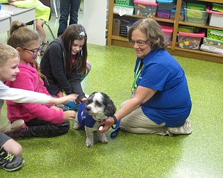 Neighbors | Zack Shively.Each of the four elementary schools had their own special guests for the Right to Read Week. The week also included special theme days where the children dressed up. The schools wanted to reward and encourage the students for reading inside and outside of school. Pictured, Robinwood Lane Elementary invited Pawz for People to their school. Ryan Piper, Gionna Sheppard and Adelynne Ganser pet Peg Will's dog, Max.