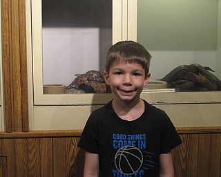 Neighbors | Zack Shively.Families visited the Ford Nature Center on Kids to Parks Day to see the animals housed at the center, explore their nature room and to make crafts with naturalist Cody Stoll. Pictured is Kenny Koby in front of the center's snakes.